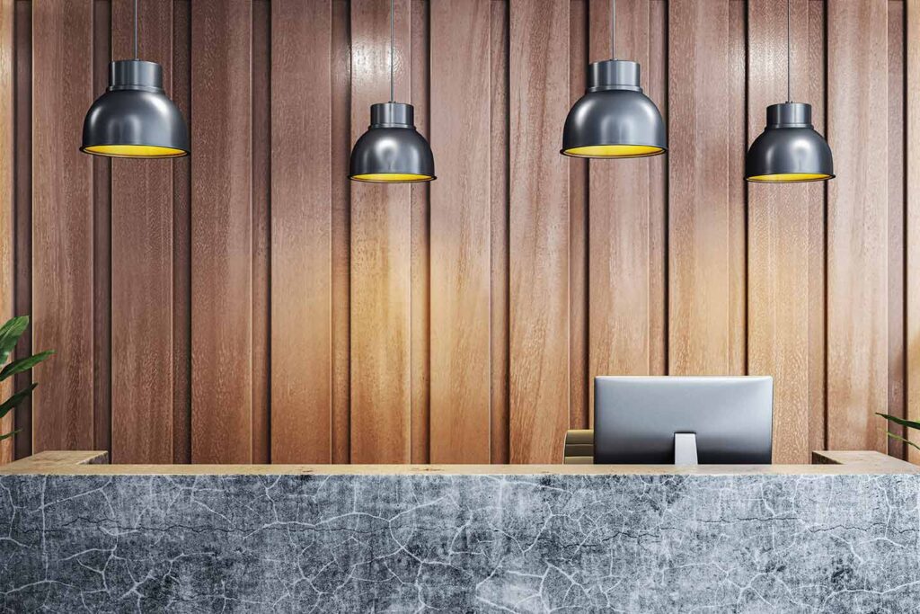 Receptionist desk with pendant lighting.