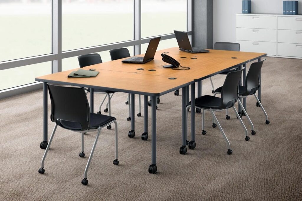 Training tables arranged in a collaborative layout with ergonomic office chairs.